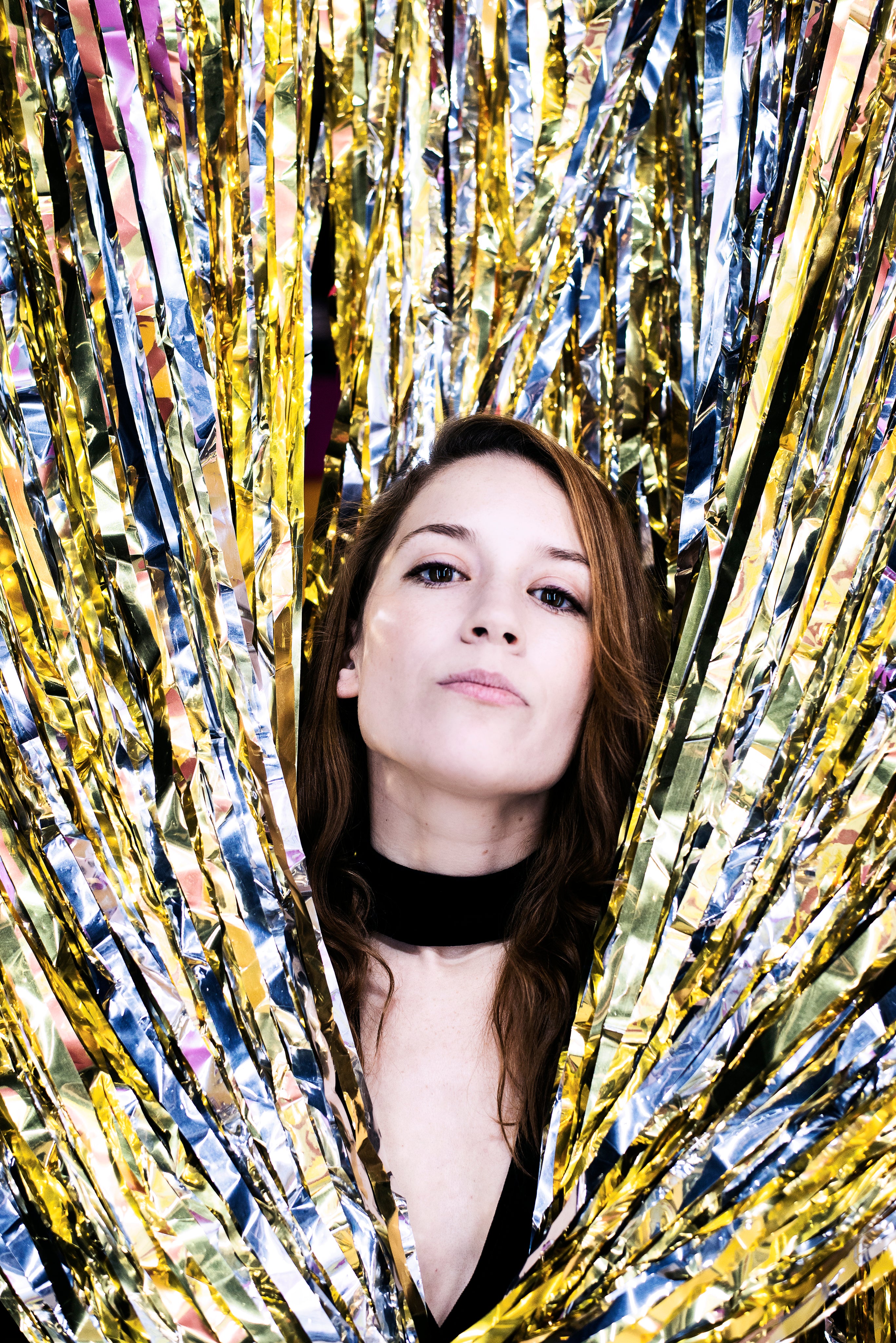 files/woman-peeks-through-silver-and-gold.jpg